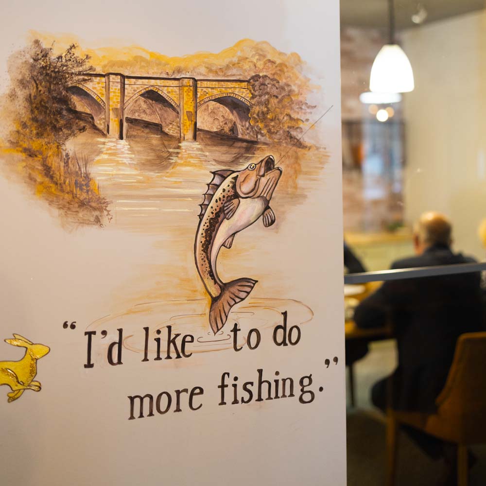 Joslin Rhodes - Wall quote that reads 'I'd like to do more fishing' painted on the wall.