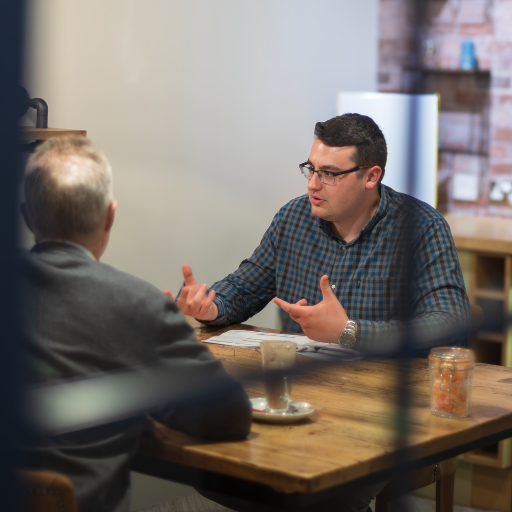 Joslin Rhodes - Financial Planner in a meeting with clients.